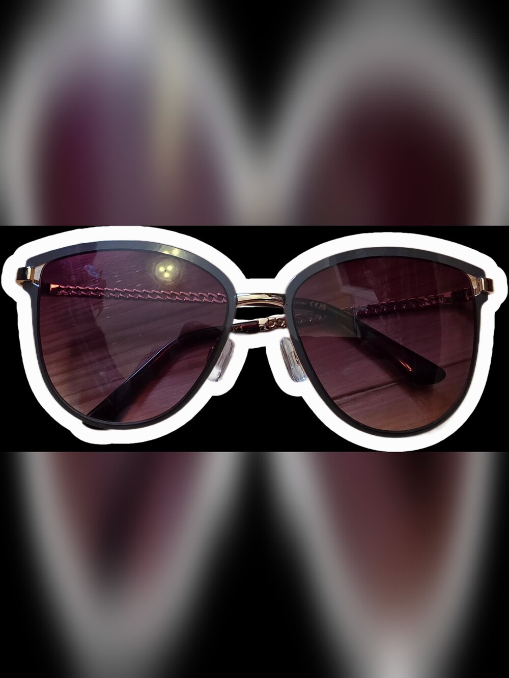 Nanette Lepore Black and Gold Cat-Eye Sunglasses with Purple-Tinted Lenses